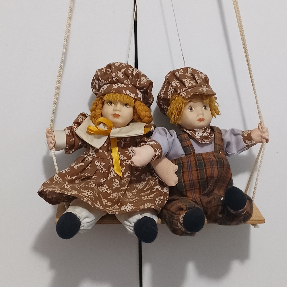 Charming Brown Doll Pair on Swing